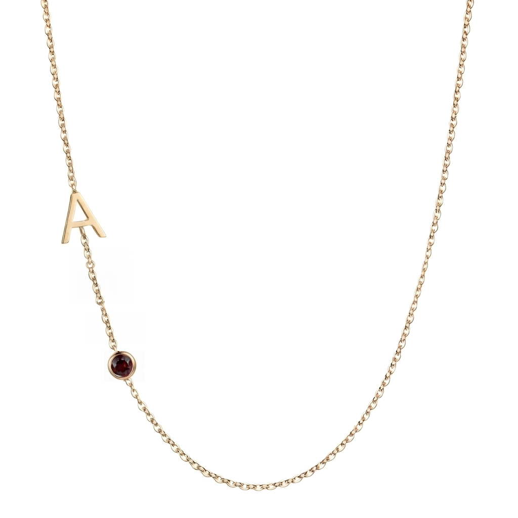 Solid 14K gold letter necklace with a genuine January garnet birthstone on a white background