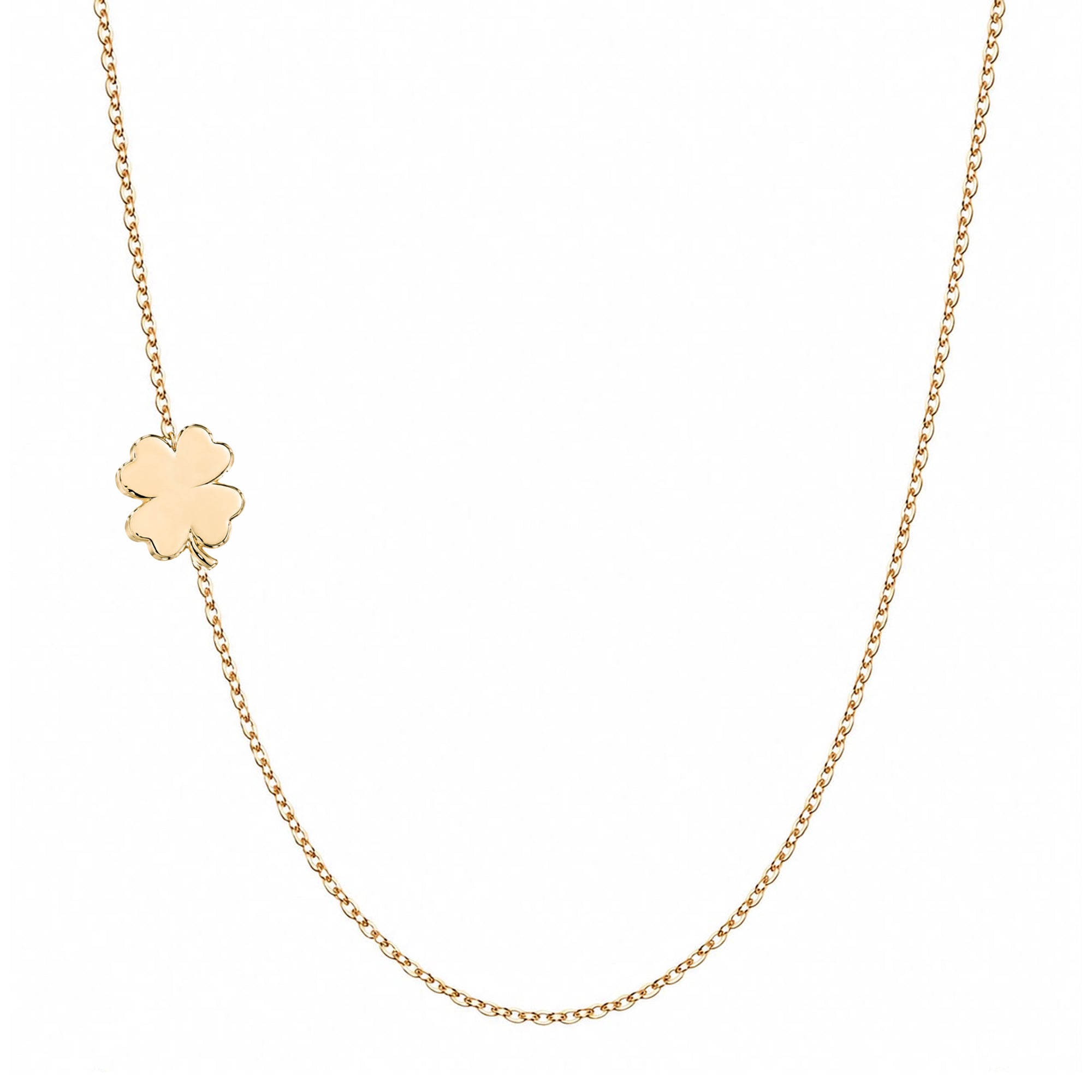 A delicate gold chain necklace featuring a small, polished gold four-leaf clover charm, displayed against a solid white background.