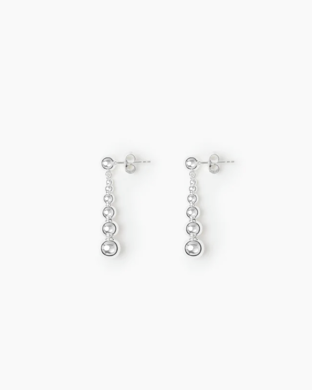 Pair of silver drop earrings on a white background