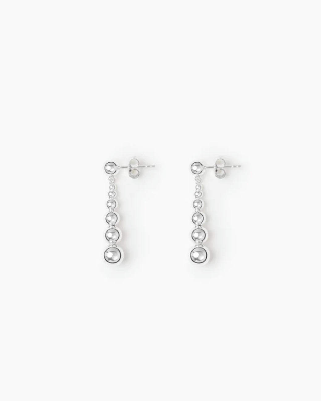 Pair of silver drop earrings on a white background