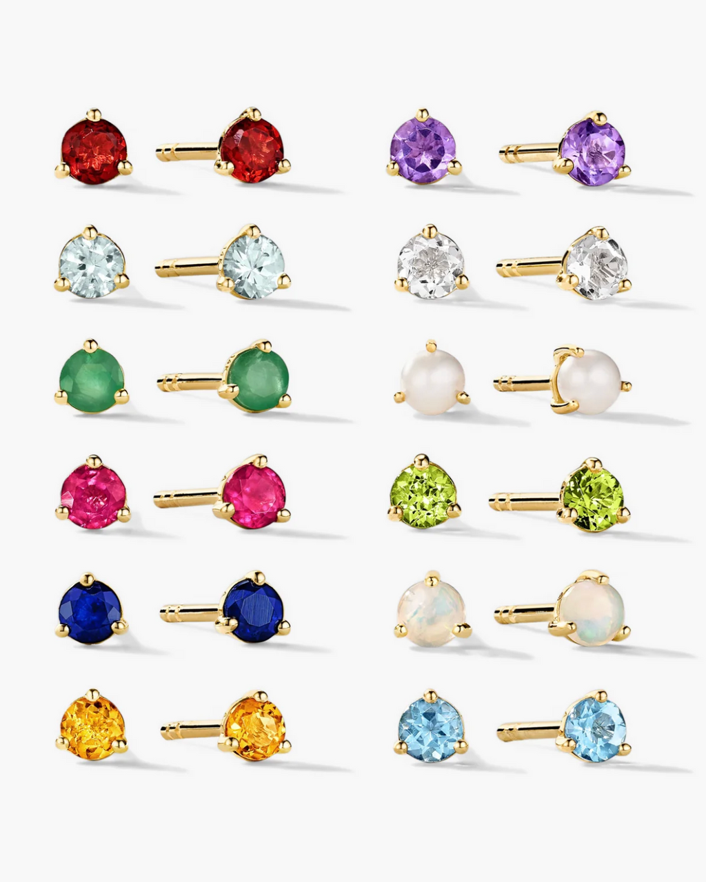 Collection of colorful gemstone stud earrings on a white background