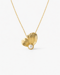 Gold necklace with a leaf-shaped pendant and pearl on a white background