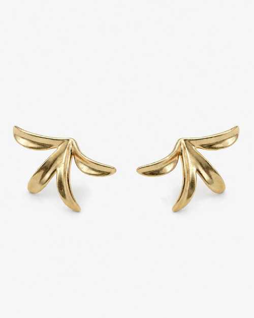 Gold leaf-shaped earrings on a white background