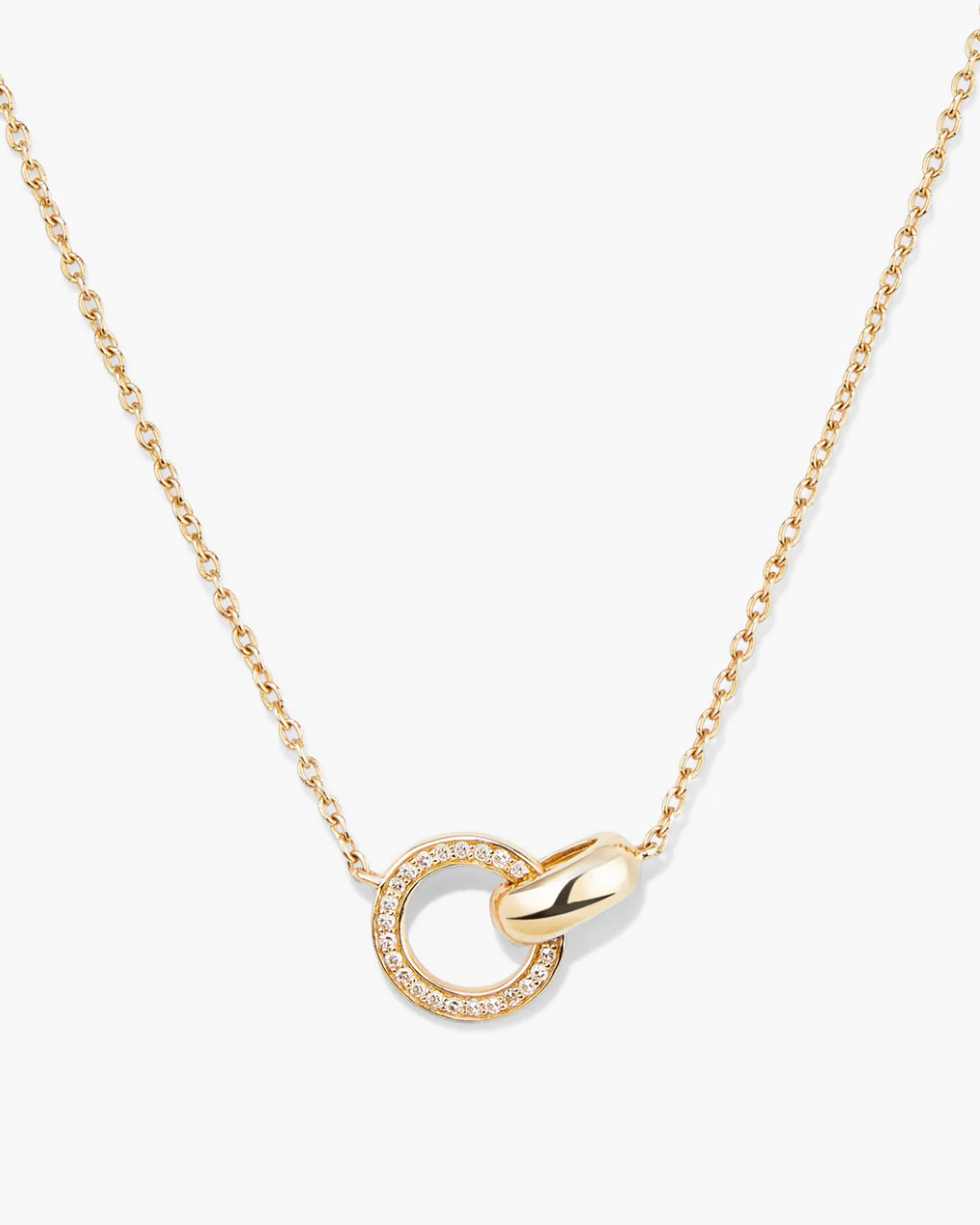 Gold necklace with a circular pendant on a white background