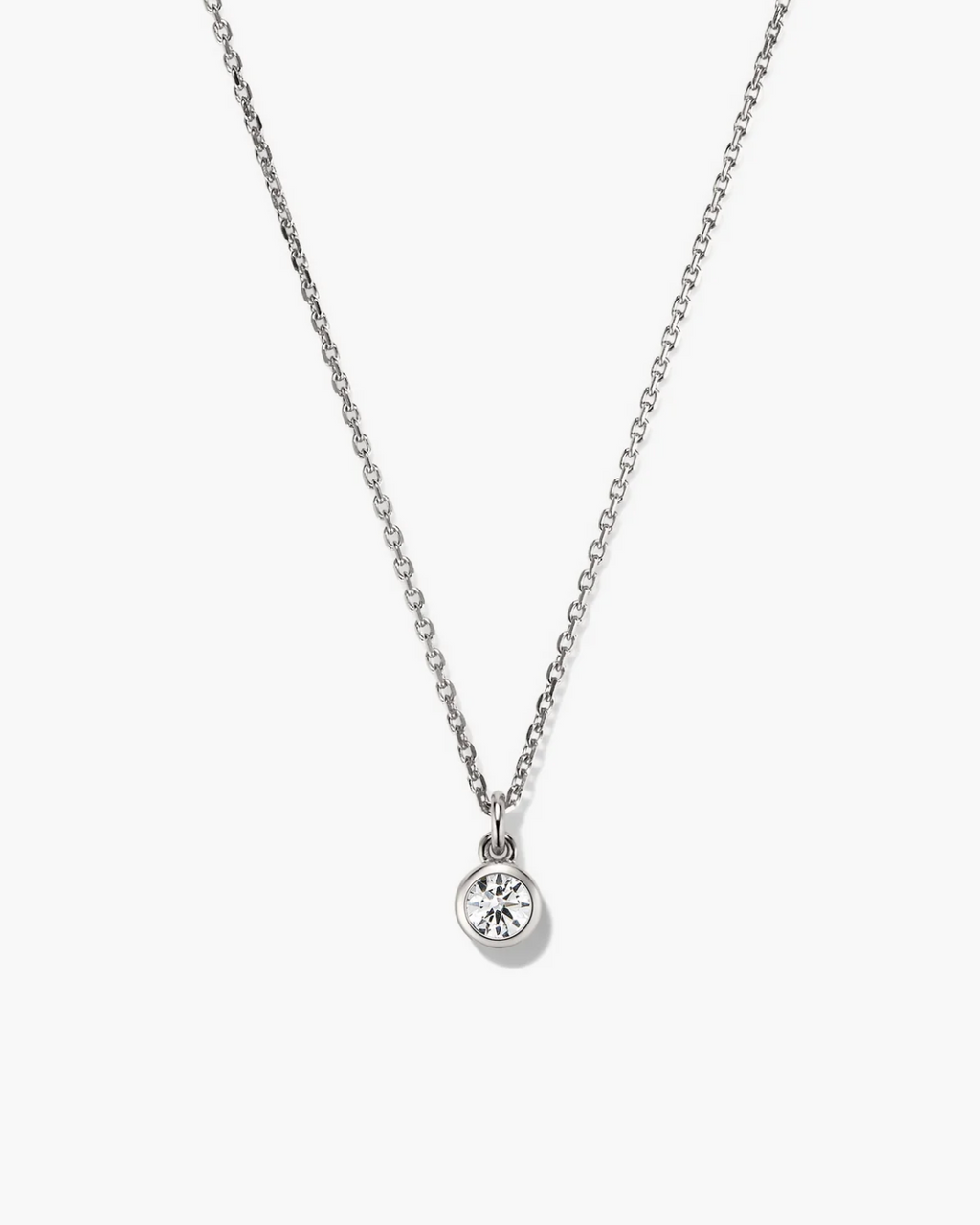 Silver necklace with a round pendant on a white background