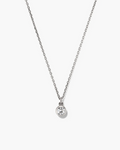 Silver necklace with a round pendant on a white background