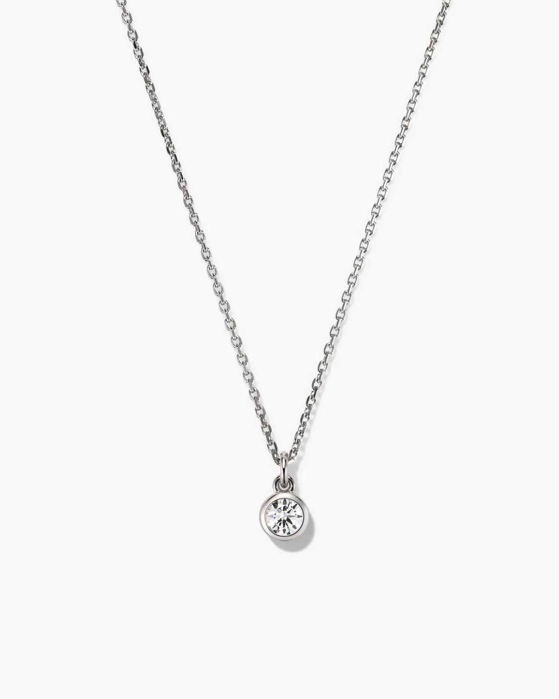 Silver necklace with a round pendant on a white background