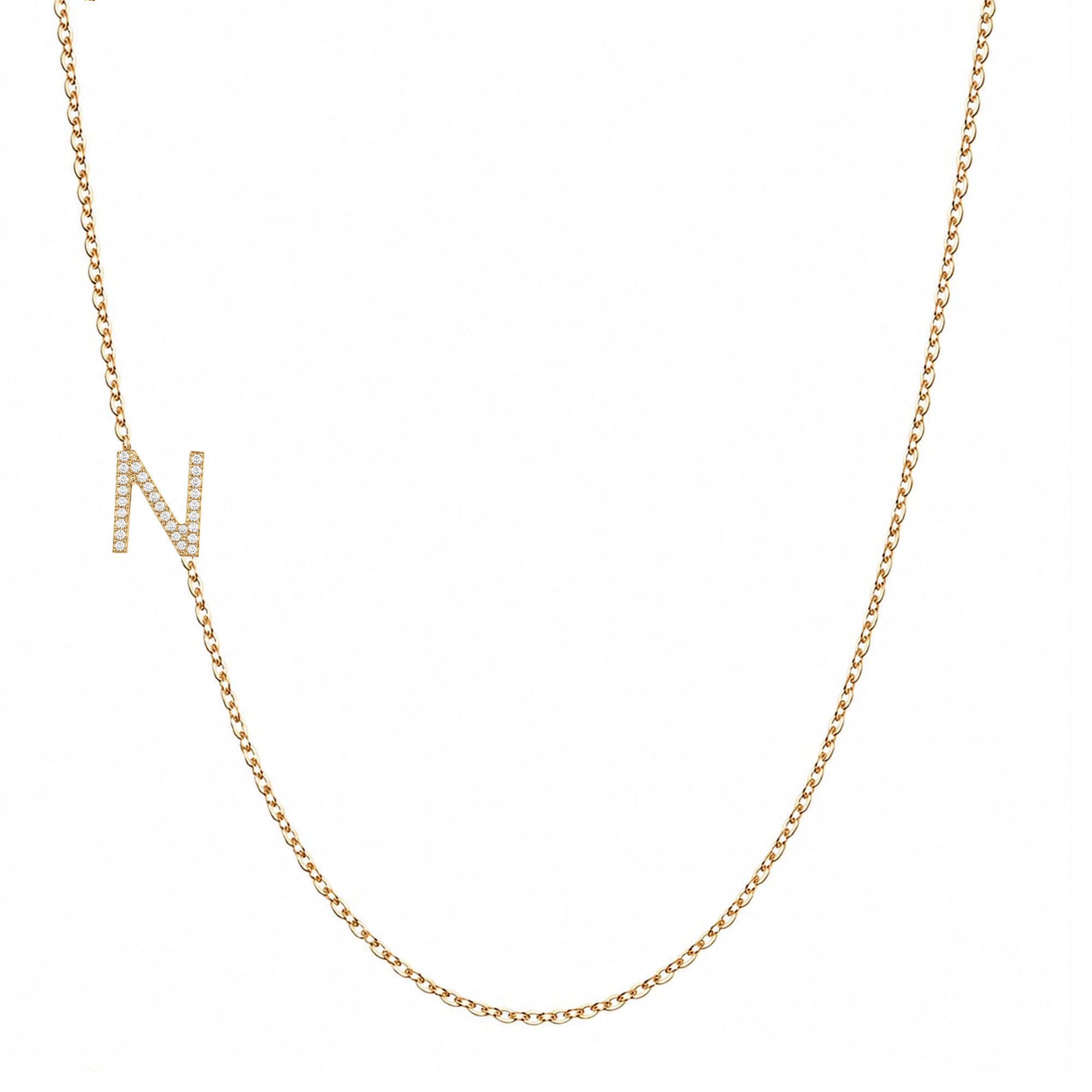 14k gold initial necklace with letter N pave diamond pendant on white background