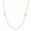 14k gold moon and star necklace on white background